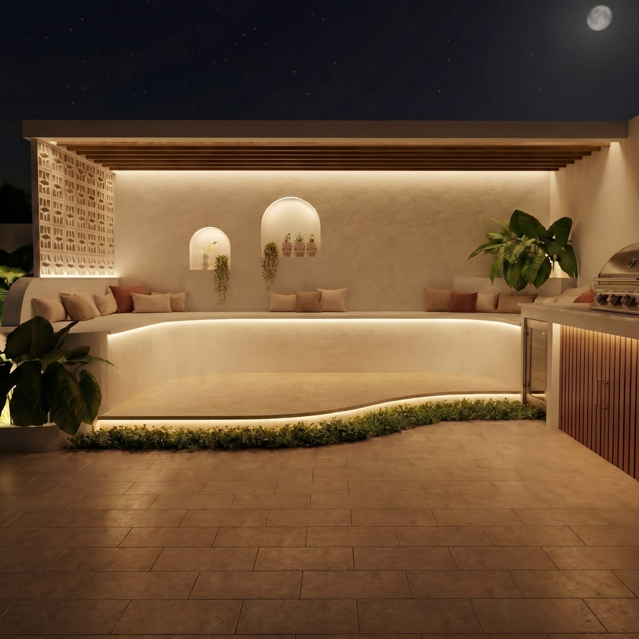 Curved outdoor kitchen and bench seating with warm strip lighting
